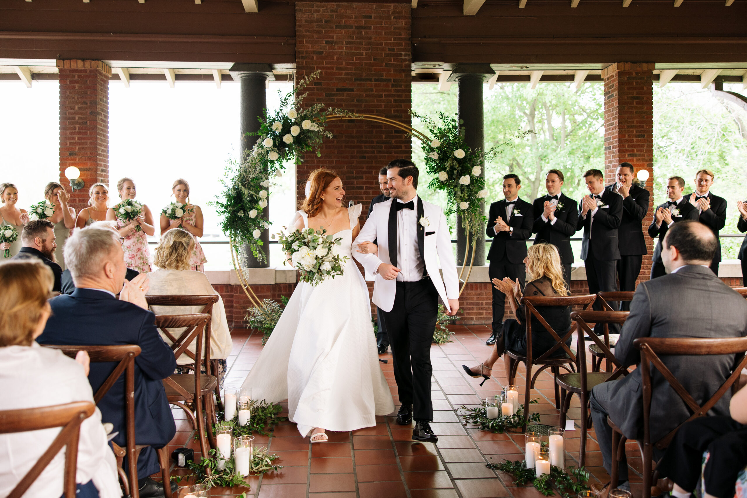 Bride and Groom walk down the isle after wedding ceremony at Cafe Brauer.